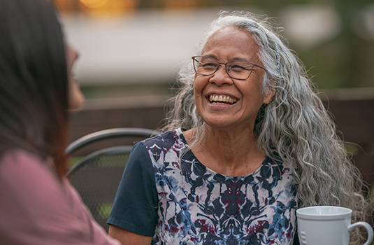 smiling lady having coffee with friend