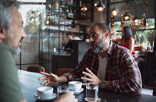 2 men talking in a coffee shop